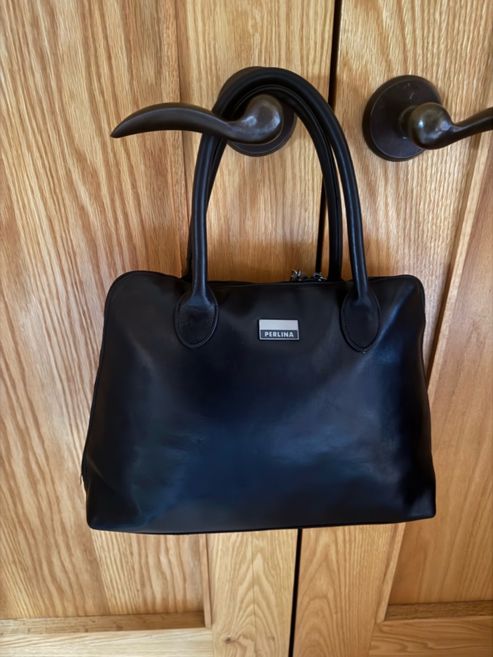 Butter soft black leather satchel with sturdy handles.Timeless design by Perlina